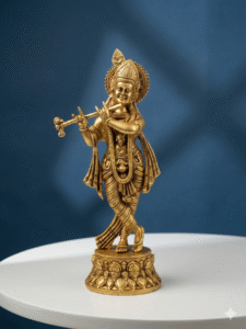 Brass Krishna Idol placed in a traditional home temple with spiritual décor