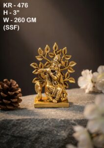 Brass Krishna Idol placed in a traditional home temple with spiritual décor